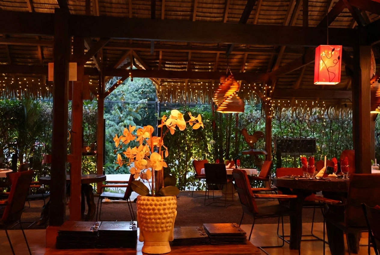 Exótica's candlelit dining room beneath a thatched jungle roof
